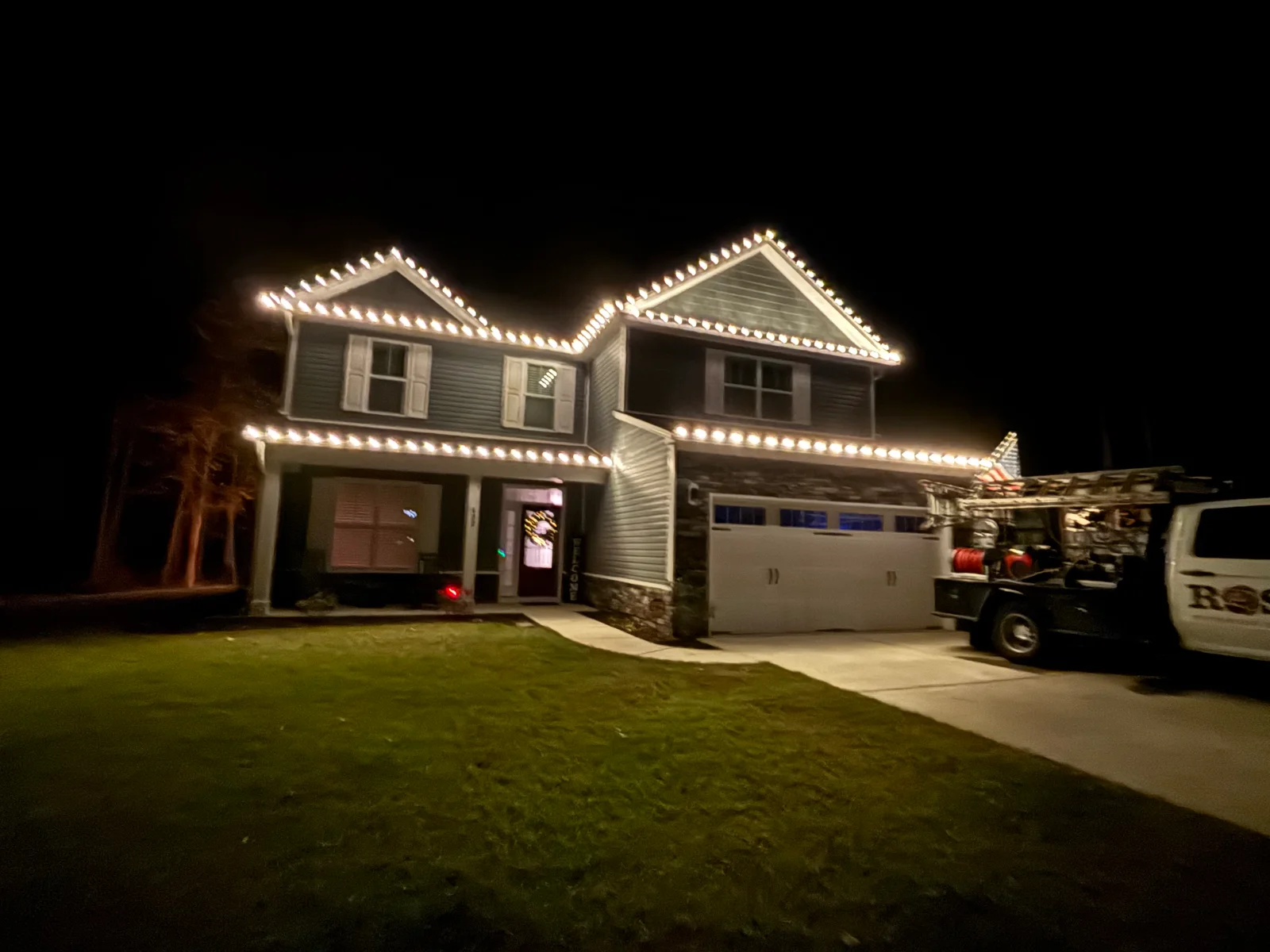 Two-story home with LED roofline and gable lighting installed along architectural edges